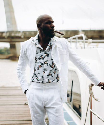 A White “Tropicana” Linen Overcoat & Wide Cut Pant Trousers.