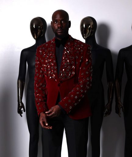 A Mahogany red shawl lapel tuxedo with black and octagonal laser-cut matching Swarovski stones suit
