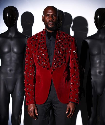 A Mahogany red shawl lapel tuxedo with black and octagonal laser-cut matching Swarovski stones suit