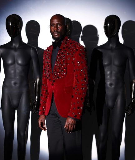 A Mahogany red shawl lapel tuxedo with black and octagonal laser-cut matching Swarovski stones suit