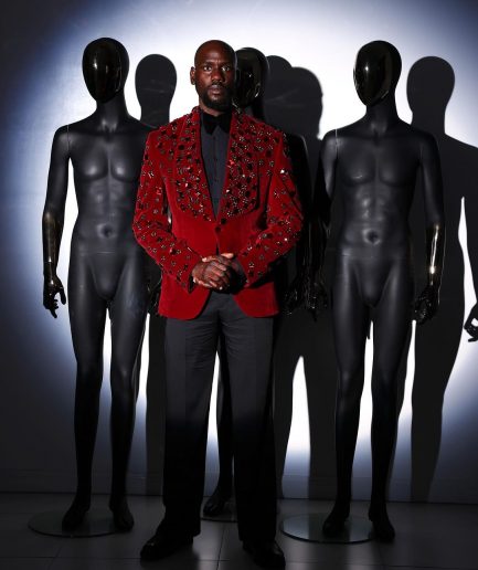 A Mahogany red shawl lapel tuxedo with black and octagonal laser-cut matching Swarovski stones suit