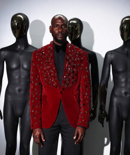 A Mahogany red shawl lapel tuxedo with black and octagonal laser-cut matching Swarovski stones suit
