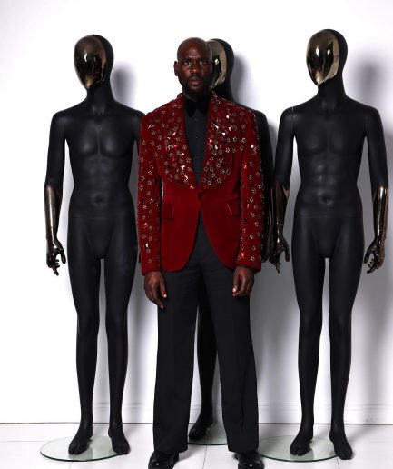 A Mahogany red shawl lapel tuxedo with black and octagonal laser-cut matching Swarovski stones suit
