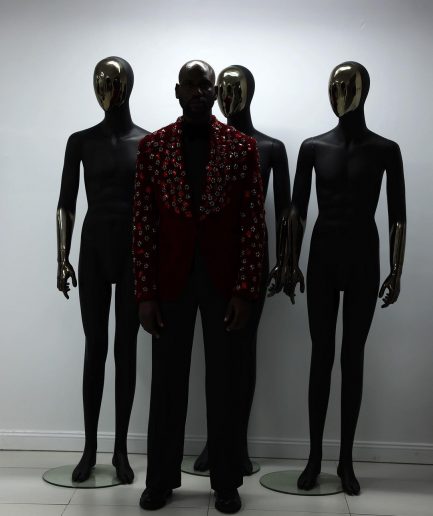 A Mahogany red shawl lapel tuxedo with black and octagonal laser-cut matching Swarovski stones suit