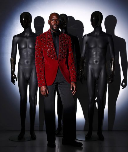 A Mahogany red shawl lapel tuxedo with black and octagonal laser-cut matching Swarovski stones suit