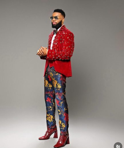 A Mahogany red shawl lapel tuxedo with black and octagonal laser-cut matching Swarovski stones suit