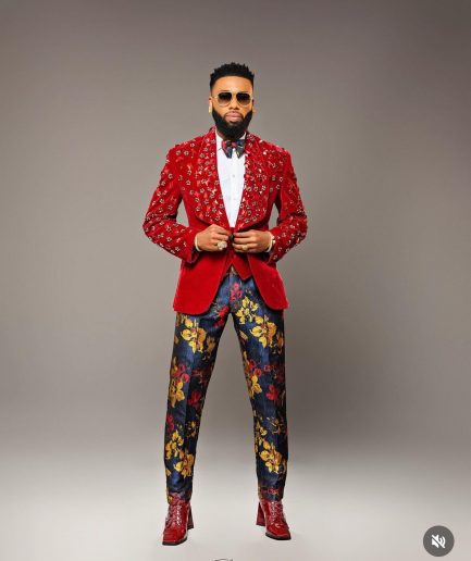 A Mahogany red shawl lapel tuxedo with black and octagonal laser-cut matching Swarovski stones suit