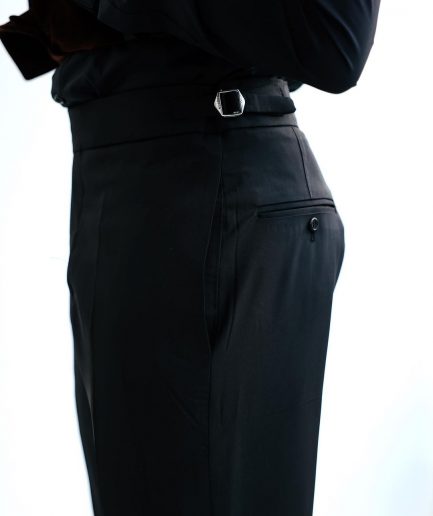 A Charcoal Black High Waist, Trumpet-Cut Details Pant With A Side Metal Adjuster.