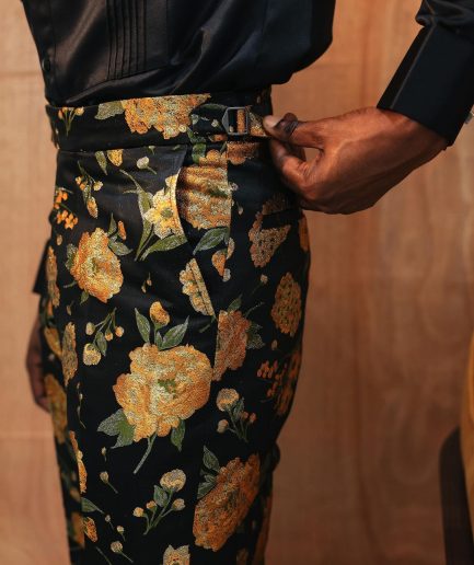 A yellow, silk black jacquard pants with a splash of gold print.