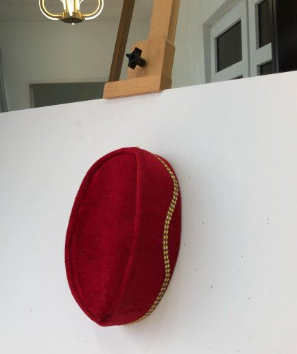 A Red and gold lines ceremonial African Traditional hat