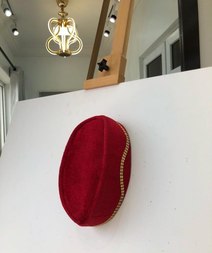 A Red and gold lines ceremonial African Traditional hat
