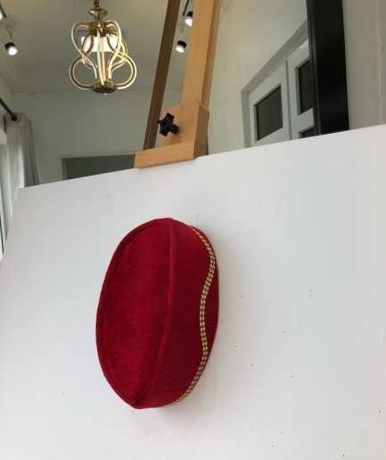A Red and gold lines ceremonial African Traditional hat