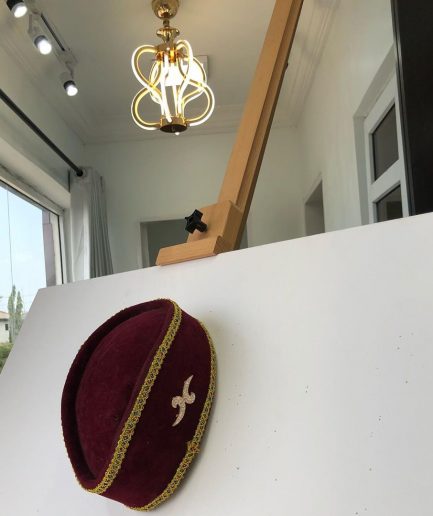 A Burgundy and Gold Ceremonial African Traditional Hat