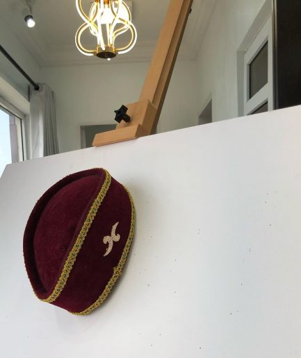 A Burgundy and Gold Ceremonial African Traditional Hat