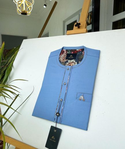 A Skye blue with paisley detailing, front flap with a matching Swarovski button detailing African kaftan and sokoto