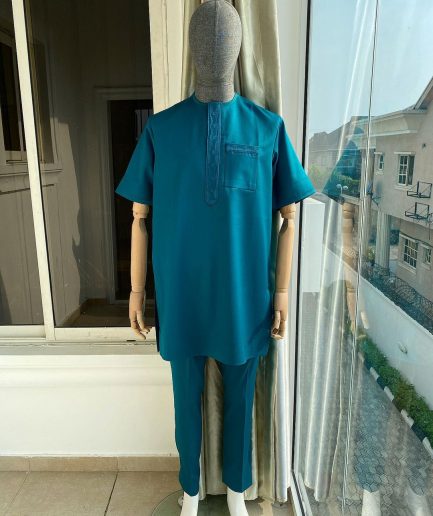 An emerald green front flap and traditional embroidery senator kaftan