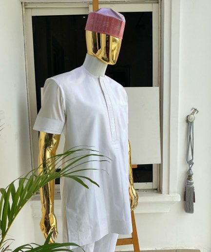 A Cocaine white voil short sleeve men’s tailored senator kaftan with a light weave pink kanuri hat