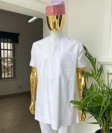 A Cocaine white voil short sleeve men’s tailored senator kaftan with a light weave pink kanuri hat