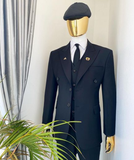 A charcoal black Bespoke reloaded “peaky blinders" peak lapel suit.
