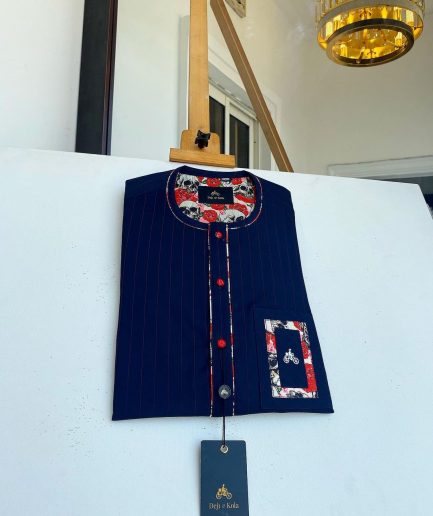 A red and midnight blue pin stripe senators kaftan with mixed red paisley pocket and neck detailing.