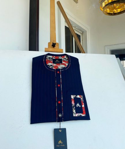 A red and midnight blue pin stripe senators kaftan with mixed red paisley pocket and neck detailing.