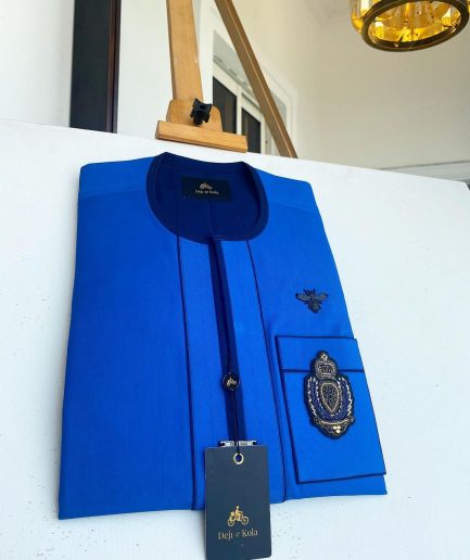 A Royal blue with navy blue mix, hand embroidery patch detailing, and black butterfly metal lapel African Kaftan