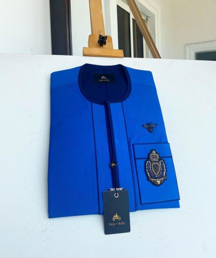 A Royal blue with navy blue mix, hand embroidery patch detailing, and black butterfly metal lapel African Kaftan