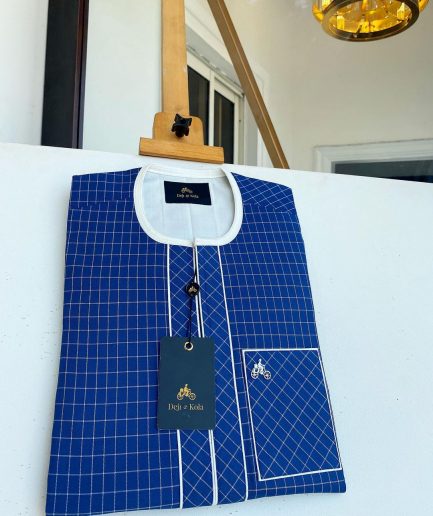 An ivory and blue check kaftan with an ivory-layered front section is a traditional African kaftan