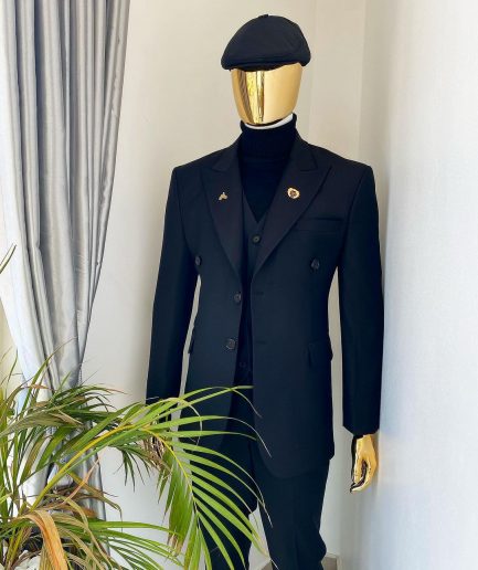 A charcoal black Bespoke reloaded “peaky blinders” peak lapel suit