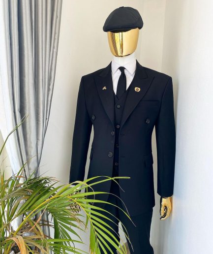 A charcoal black Bespoke reloaded “peaky blinders" peak lapel suit.