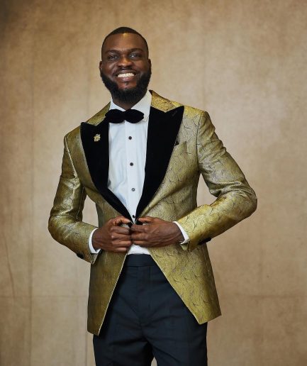 A gold metallic jacquard peak lapel tuxedo suit