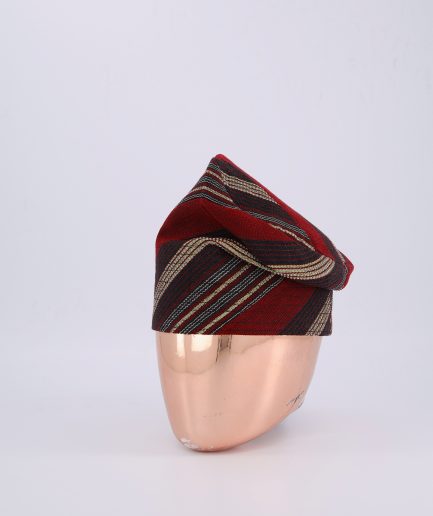 A Burgundy Knitted Yoruba Fila with a Striped Pattern.