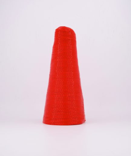 A red conical-shaped traditional hand-beaded crown cap