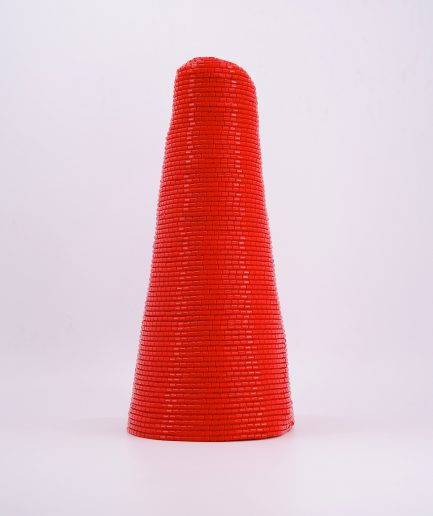 A red conical-shaped traditional hand-beaded crown cap